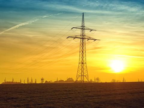 Photo of electric wires against a sunset.