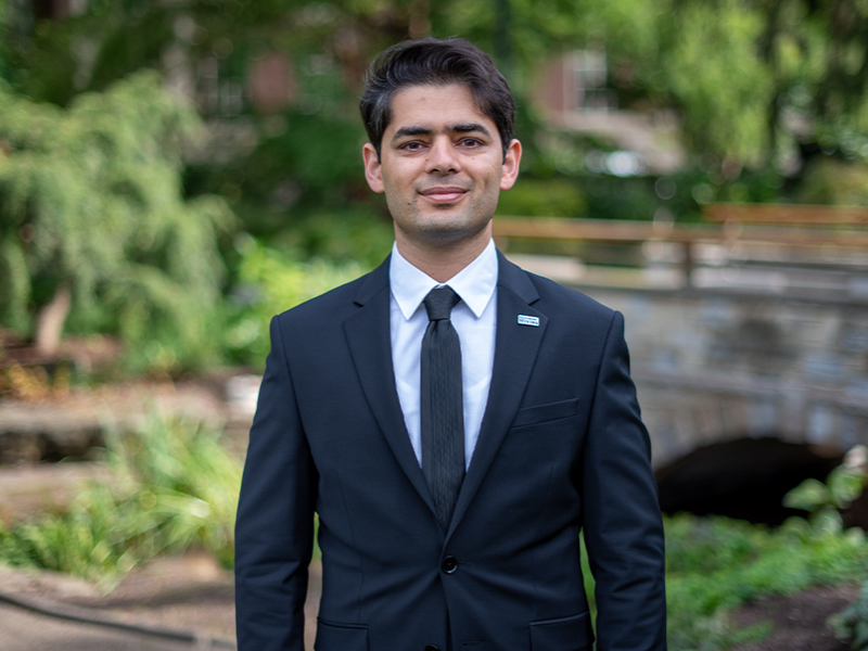 Shekarian headshot, man standing in suit and tie