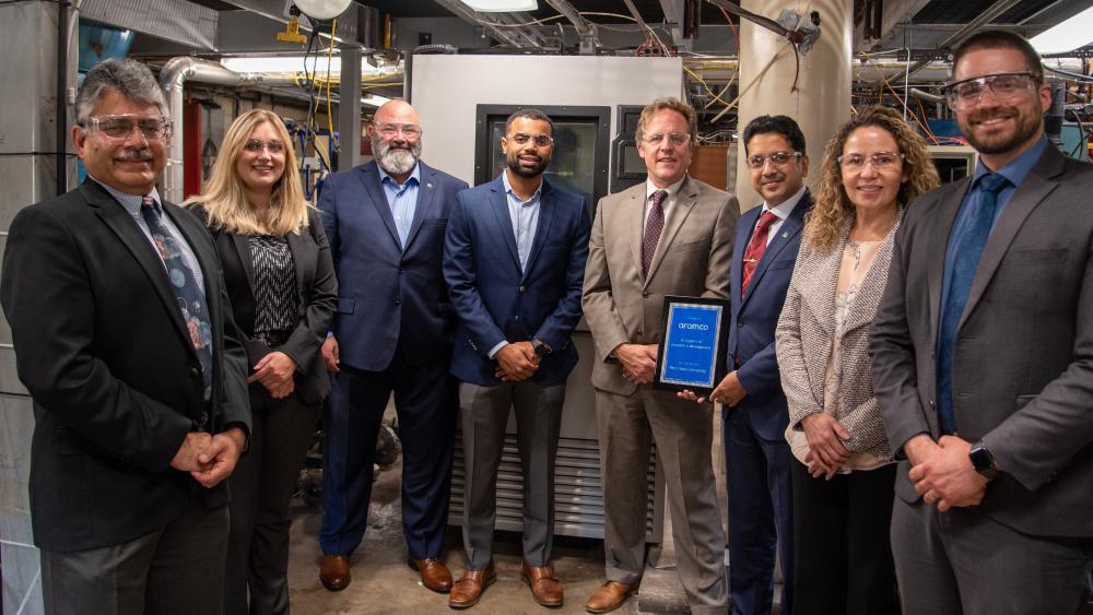 Group of people standing in front of new humidity chamber.